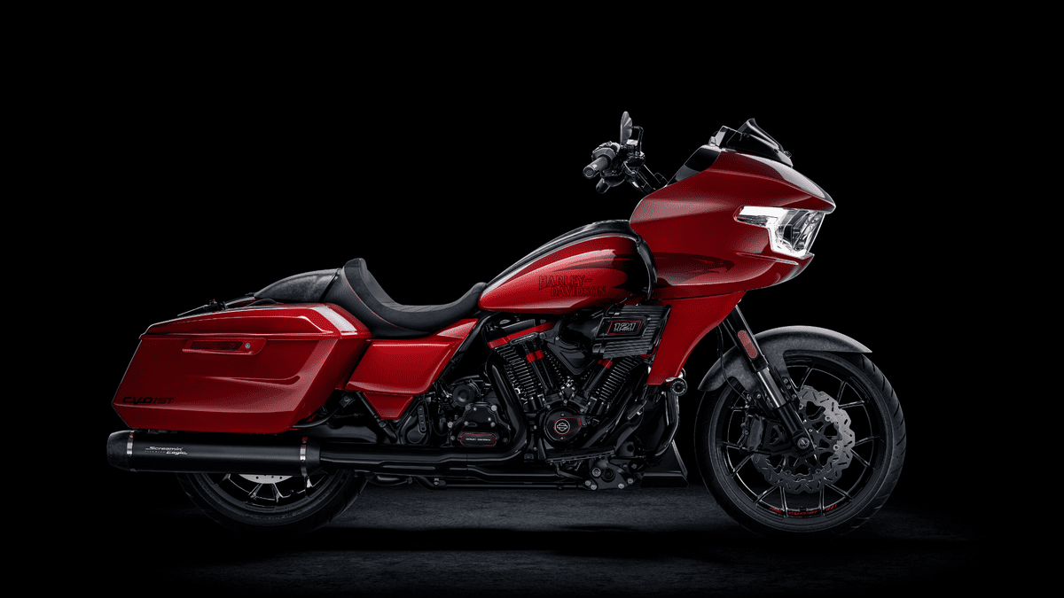 A red 2025 Harley-Davidson® CVO™ Road Glide® ST motorcycle displayed against a sleek black background in Houston, TX. vailable at Stubbs Harley-Davidson®