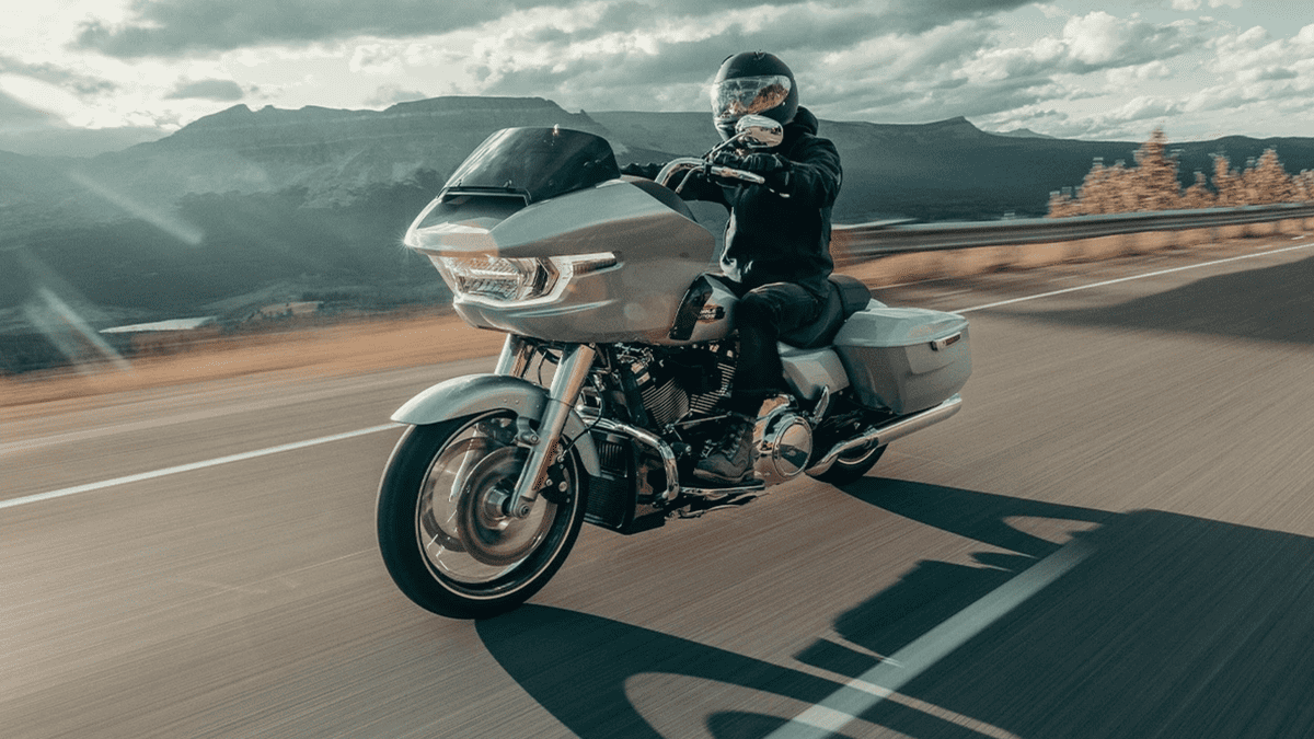 Rider enjoying a scenic highway ride on the 2025 Harley-Davidson® Road Glide® near Missouri City, TX, showcasing its aerodynamic fairing and modern touring performance.