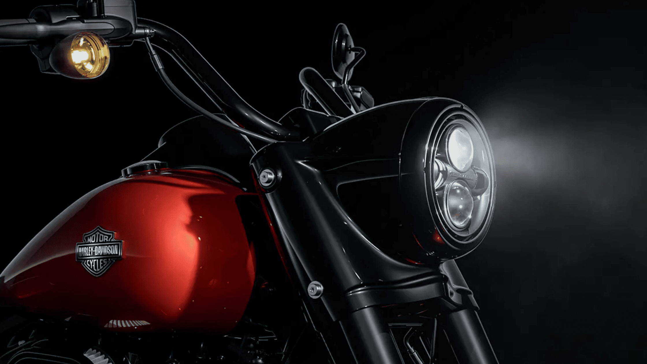 Close-up view of a red 2025 Harley-Davidson® Road King® Special motorcycle, headlight on, showcased in Houston, TX.