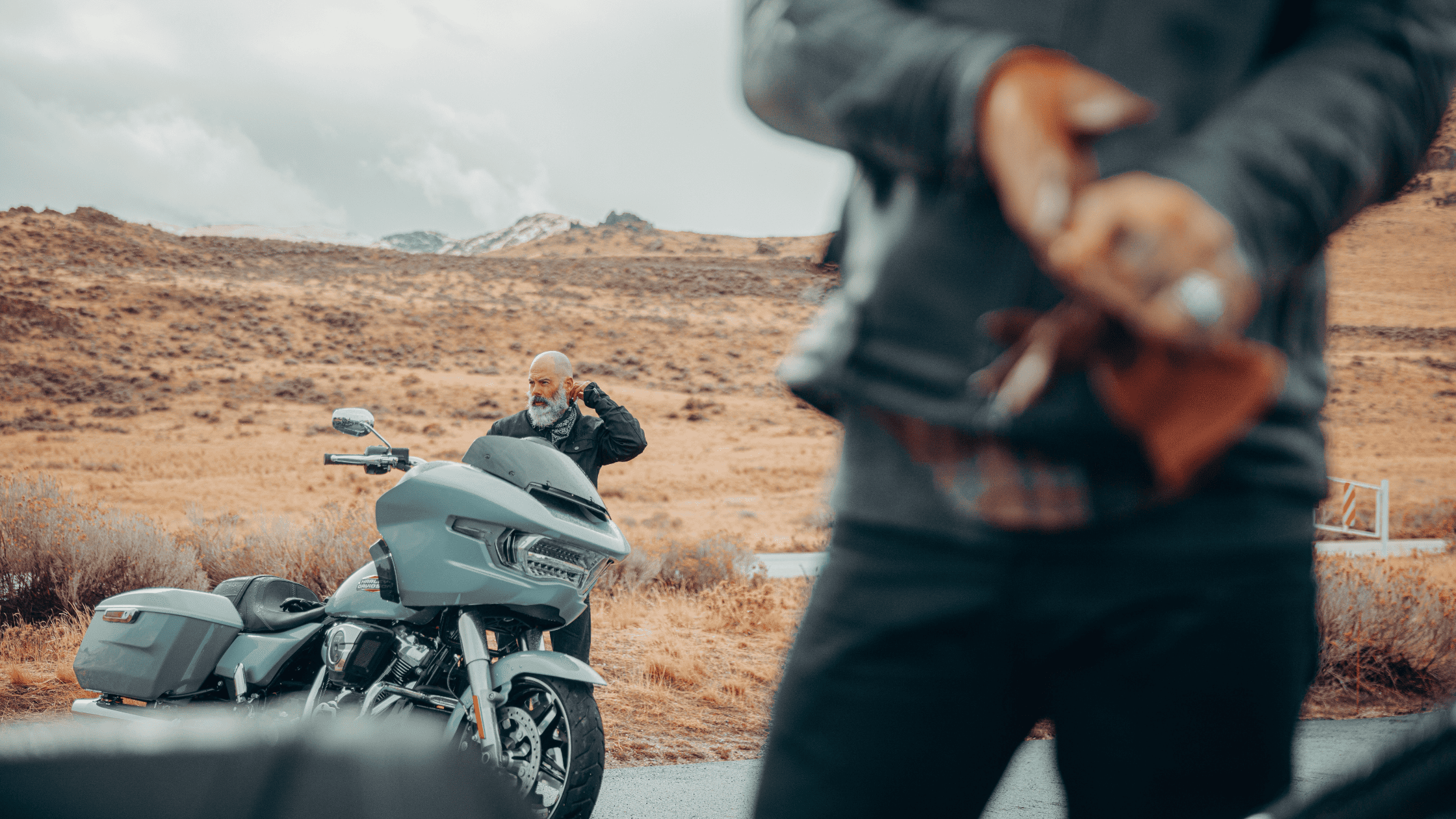 A man stands proudly beside a 2025 Harley-Davidson® Road Glide® on a scenic road in Houston, TX.