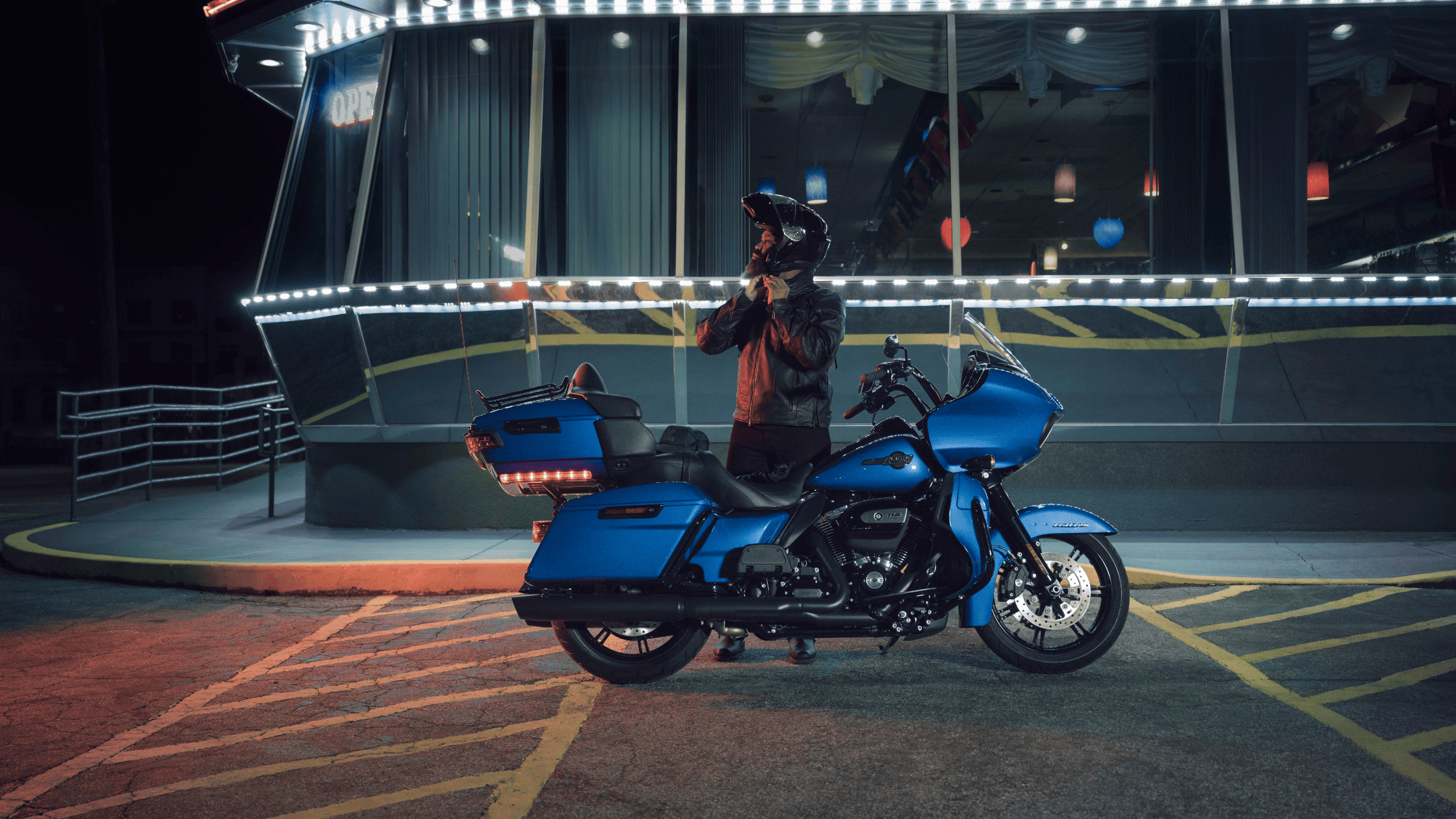 Elegant 2020 Harley-Davidson Road Glide® Limited photographed in a parking lot, highlighting its distinctive features and modern appeal.